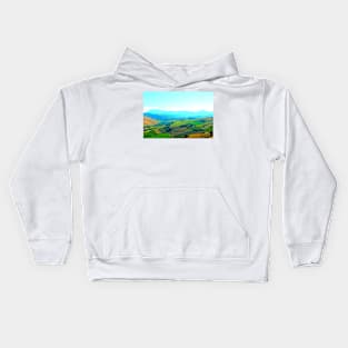 Scenery in Carassai with rolling fields and hazy mountains in the background Kids Hoodie